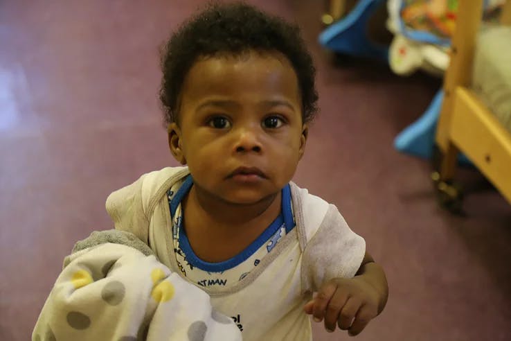 Child in a white shirt with a blue collar