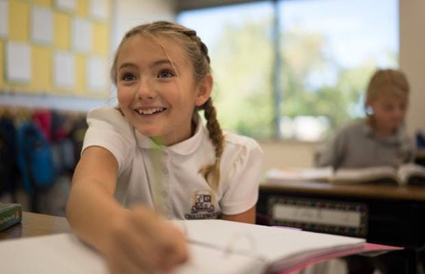Child sitting at a desk in a classroom
