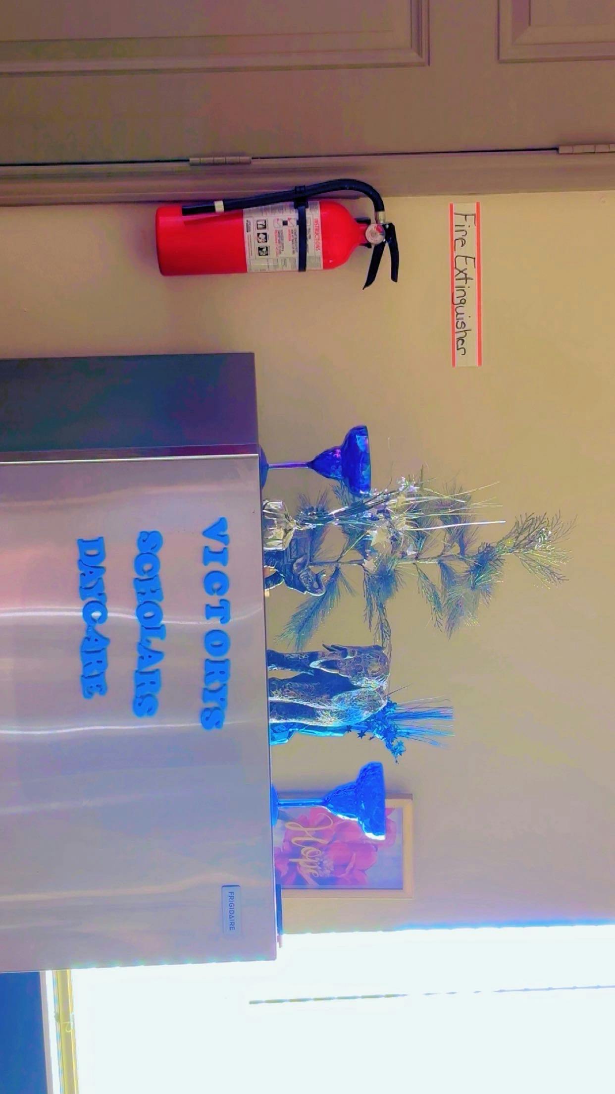 Fire extinguisher mounted on a wall with a sign that reads "Fire Extinguisher"