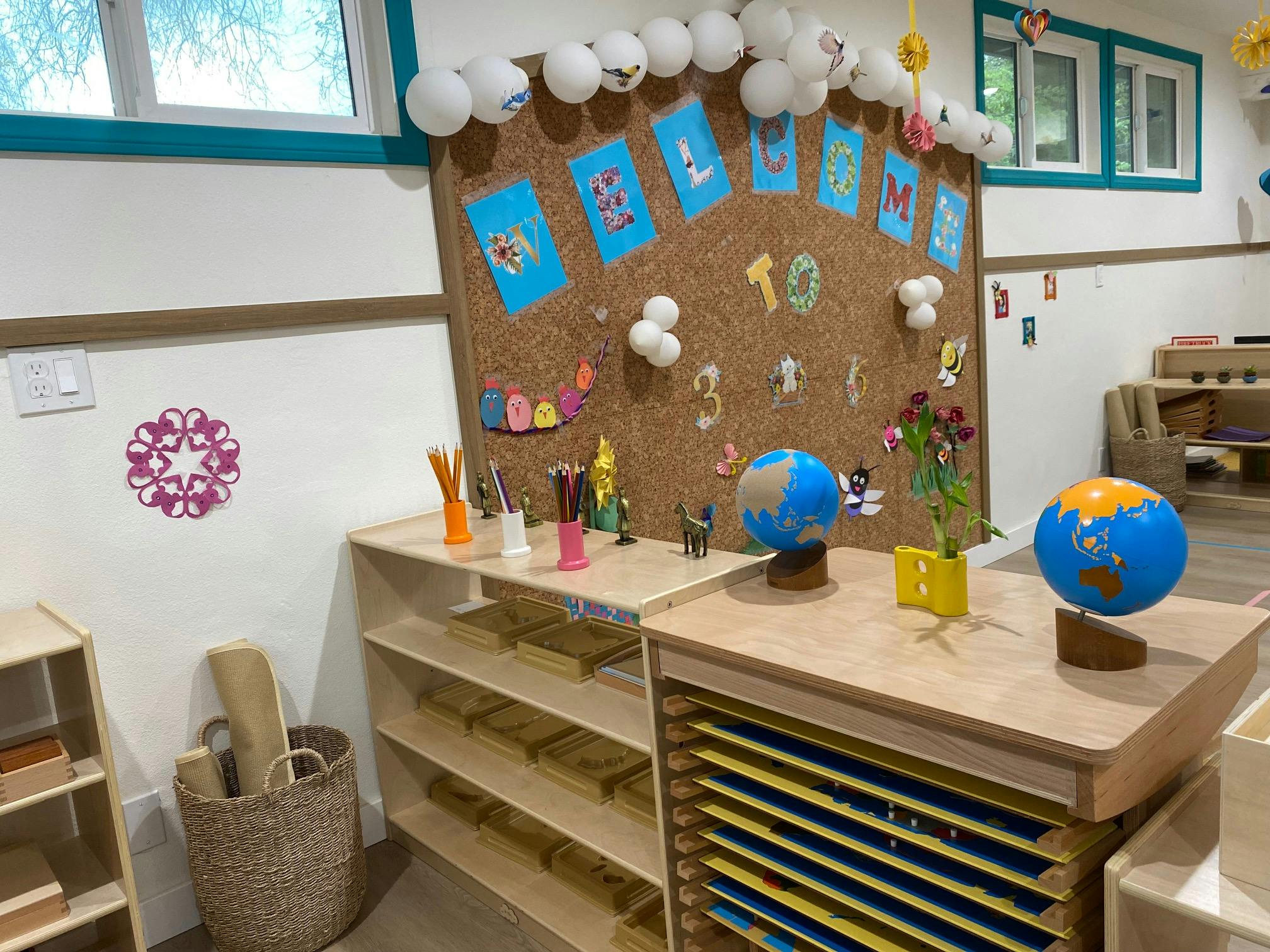 Classroom with cork board display, globes, and shelves