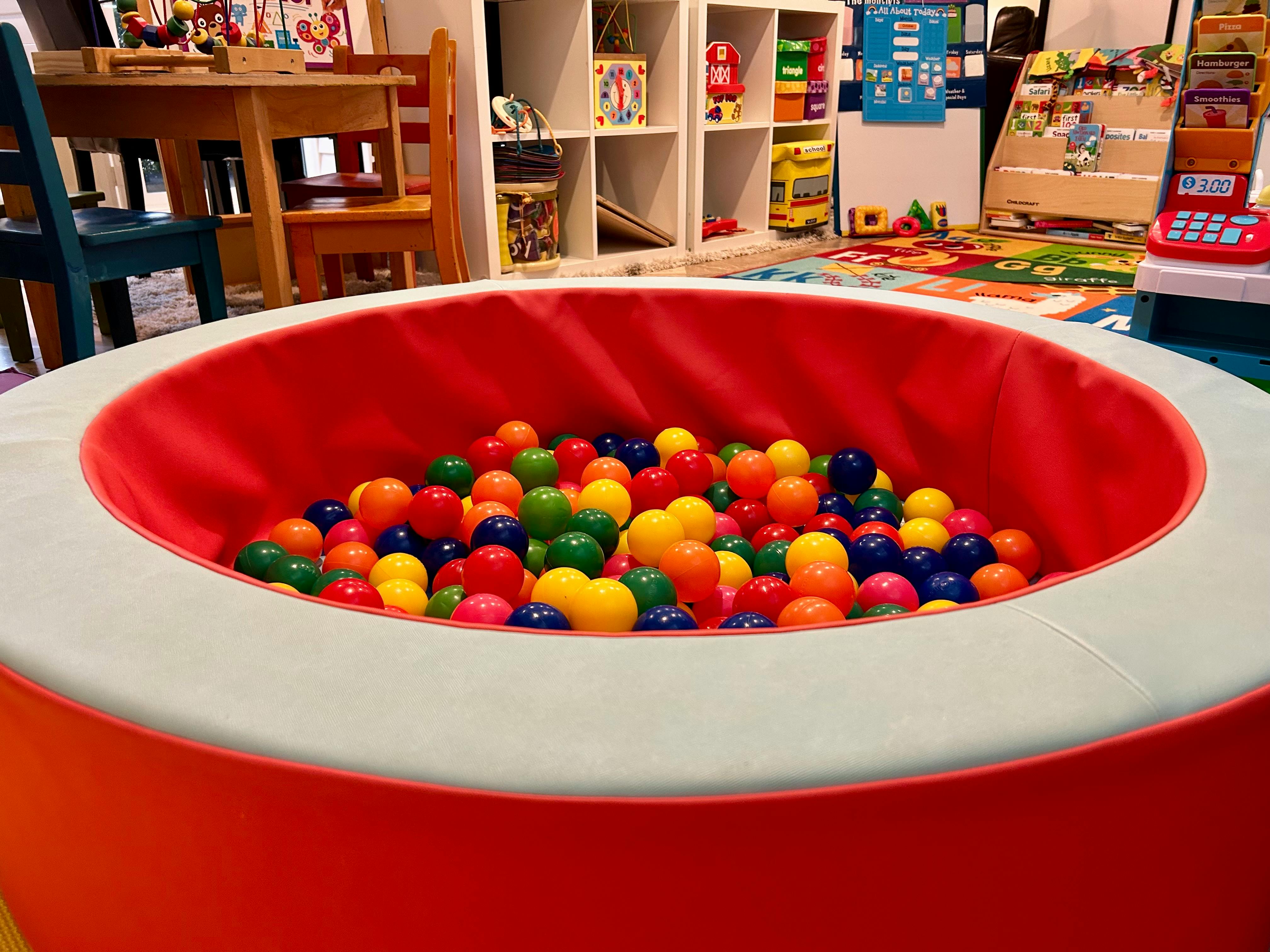 Ball pit filled with colorful plastic balls in a playroom
