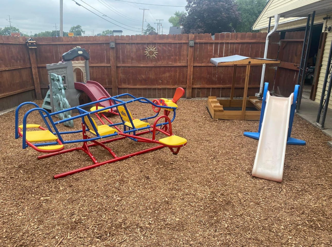 Playground with a seesaw, slide, and sandbox