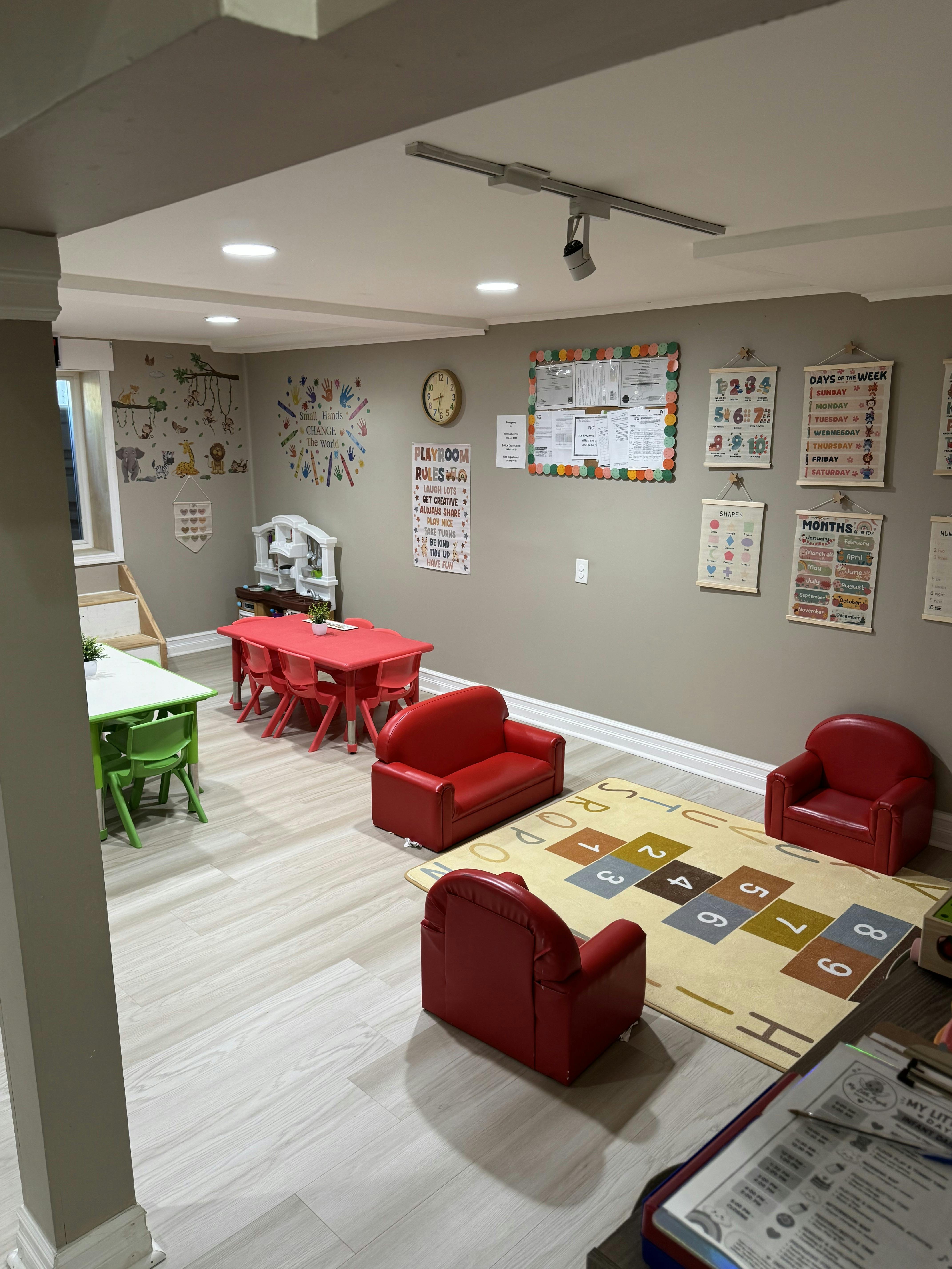 Classroom interior with child-sized furniture and educational wall charts