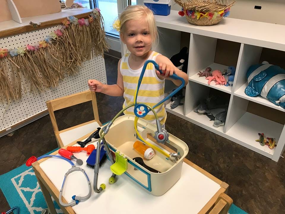 Child playing with a toy doctor kit