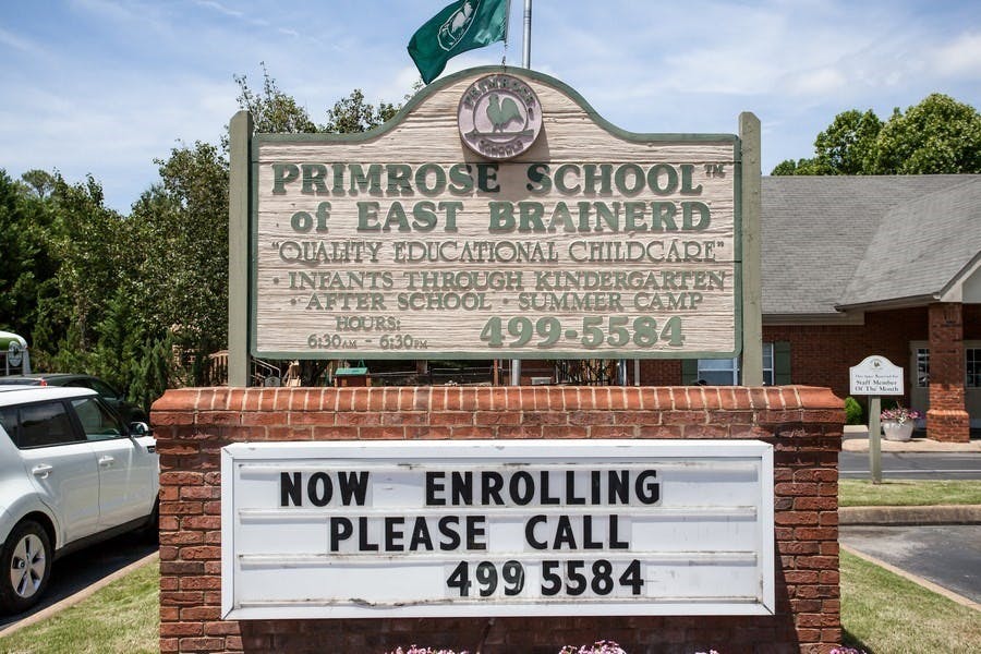Primrose School of East Brainerd sign with "Now enrolling" message