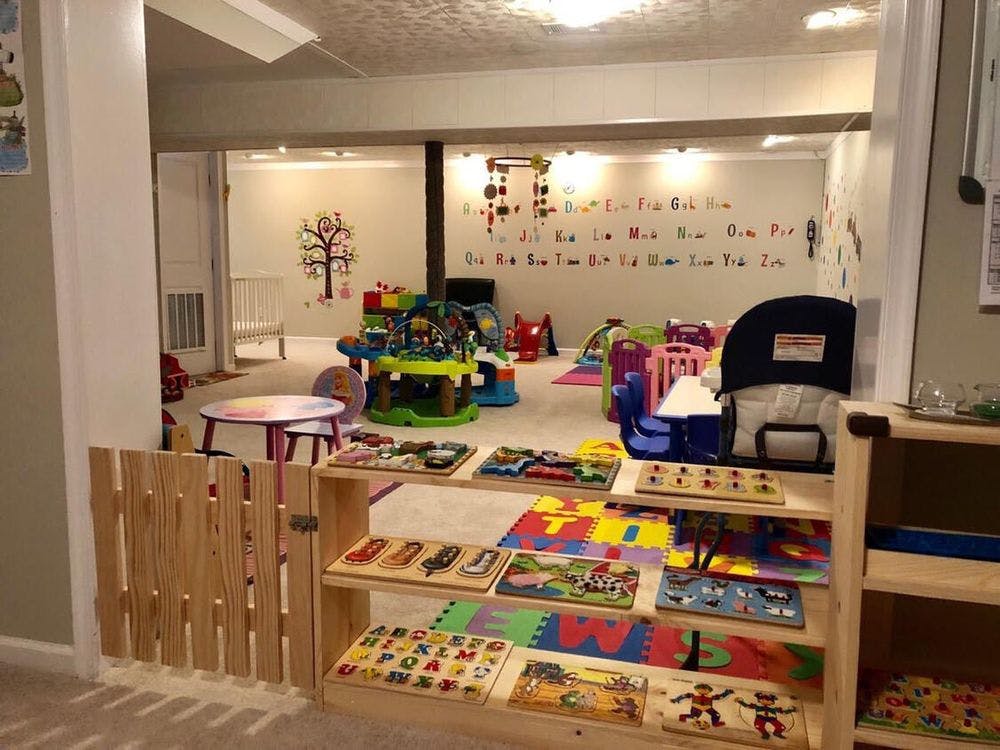 Playroom with toys, puzzles, and alphabet letters on the wall