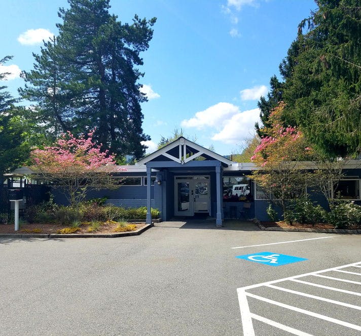 Building entrance with a covered walkway and a handicapped parking space