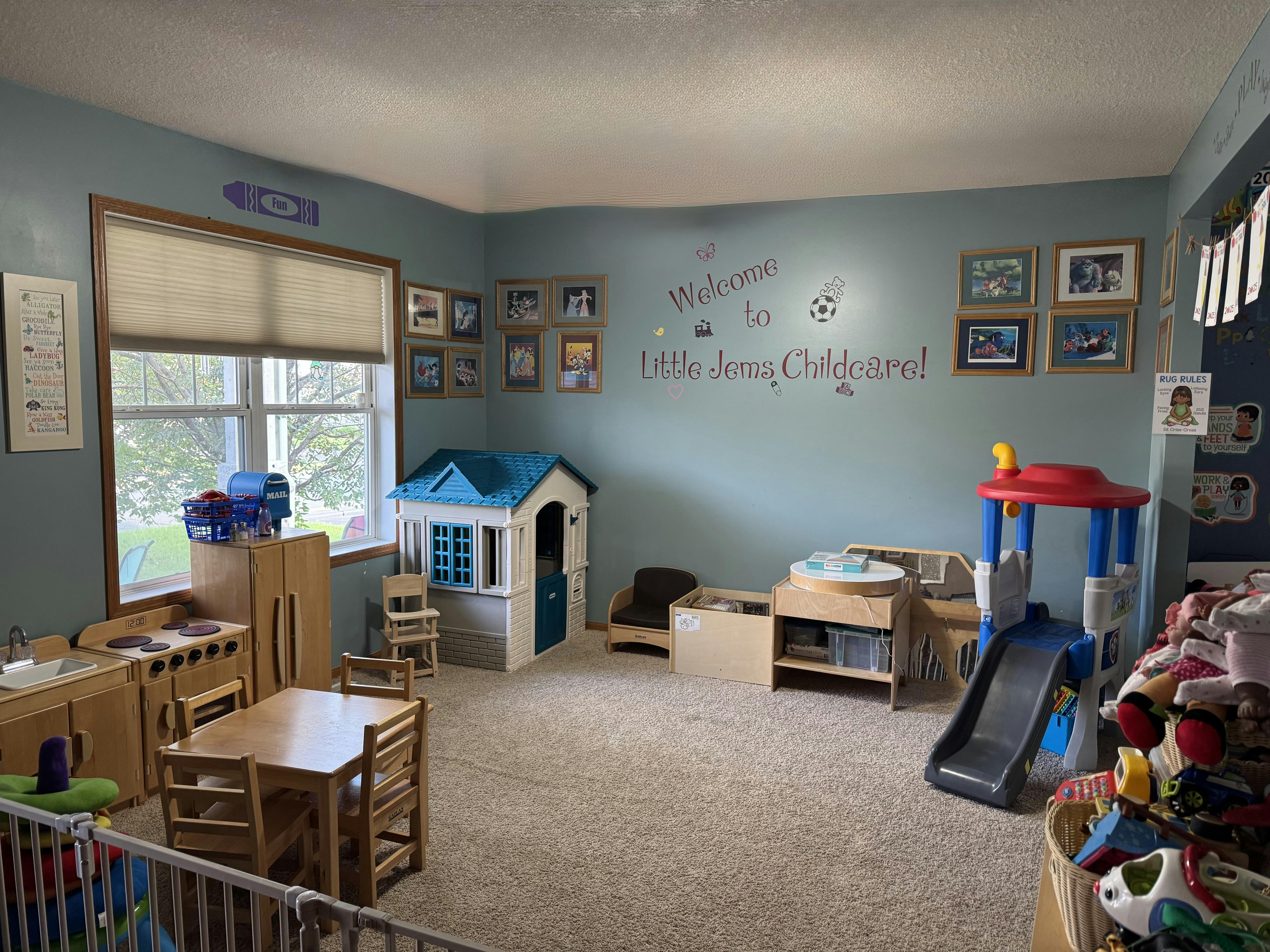 Playroom with a small table and chairs, playhouse, and slide
