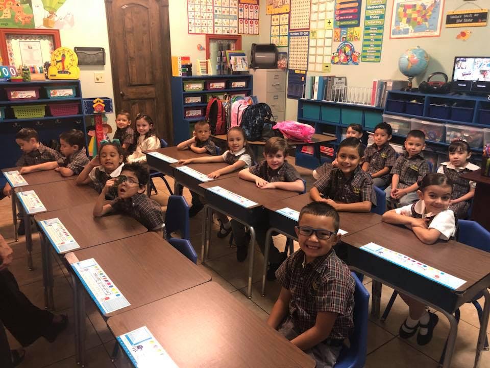 Children sitting at desks in a classroom
