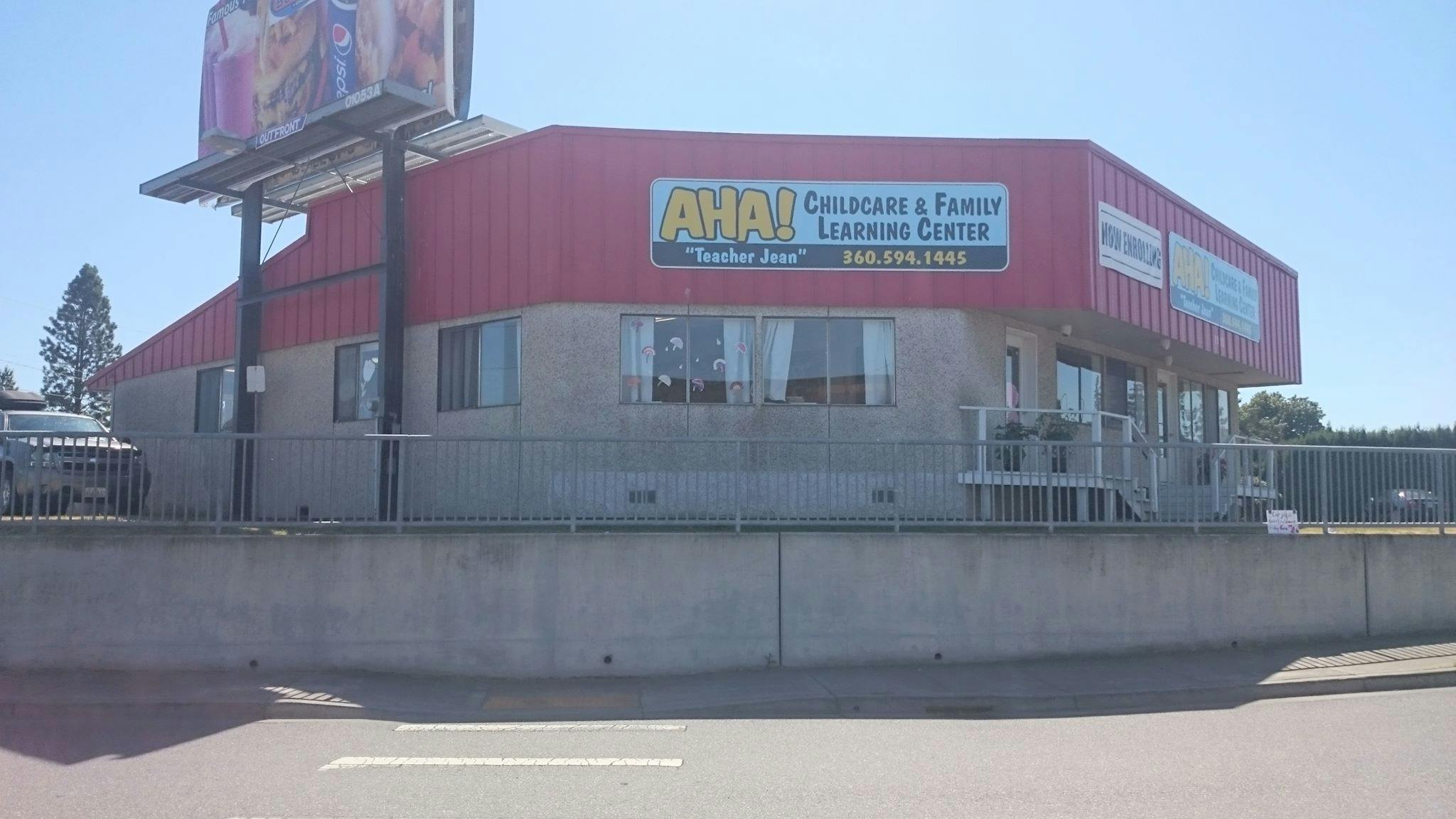 Building with red roof and "Childcare & Family Learning Center" sign