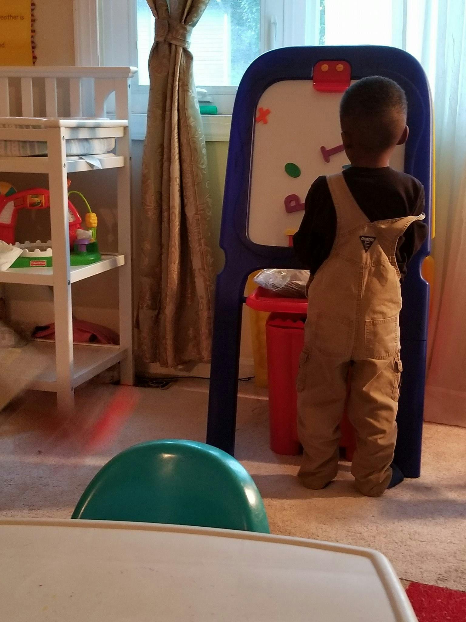 Child standing at an easel with magnetic letters