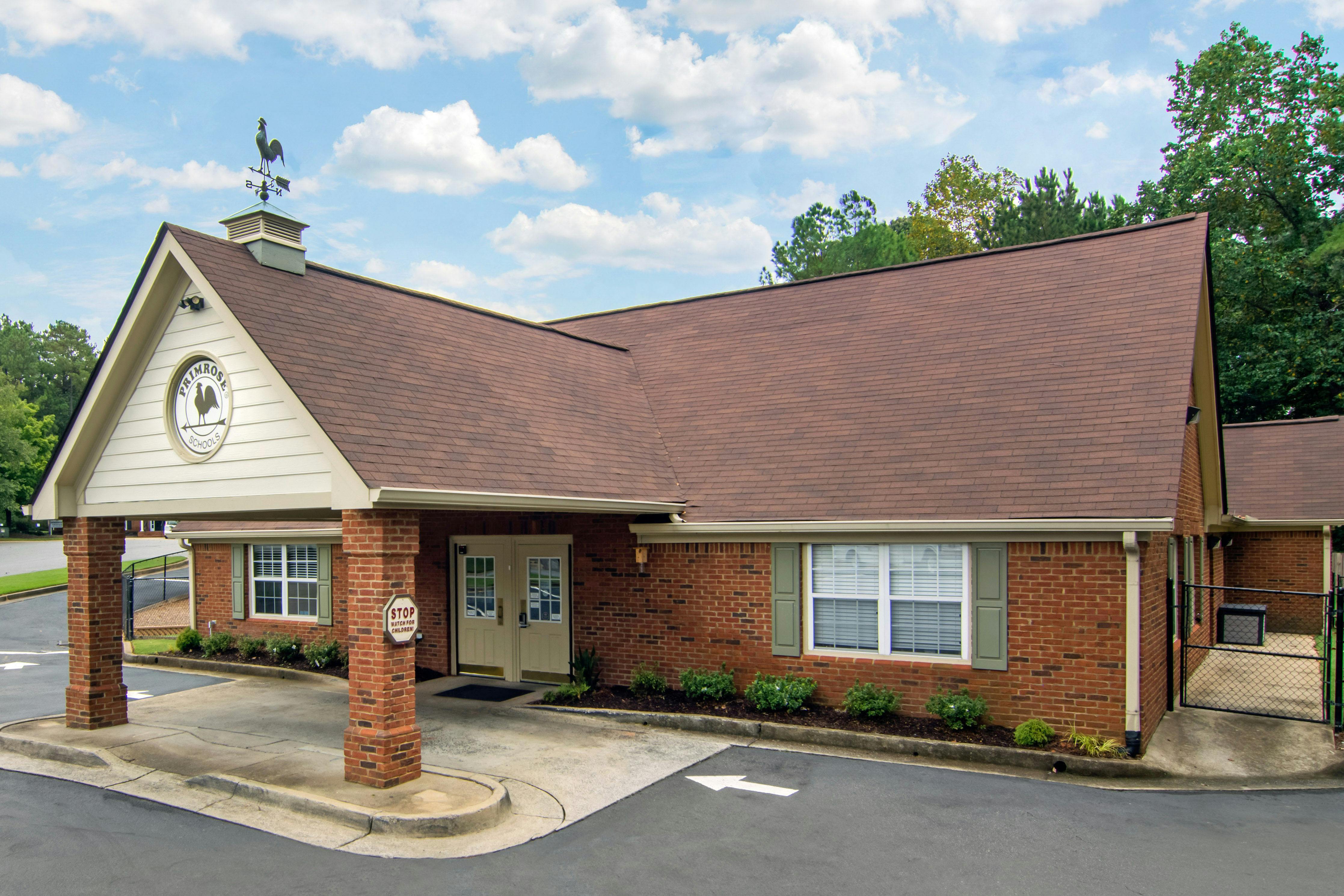 Brick building with a brown roof and a Primrose Schools sign above the entrance