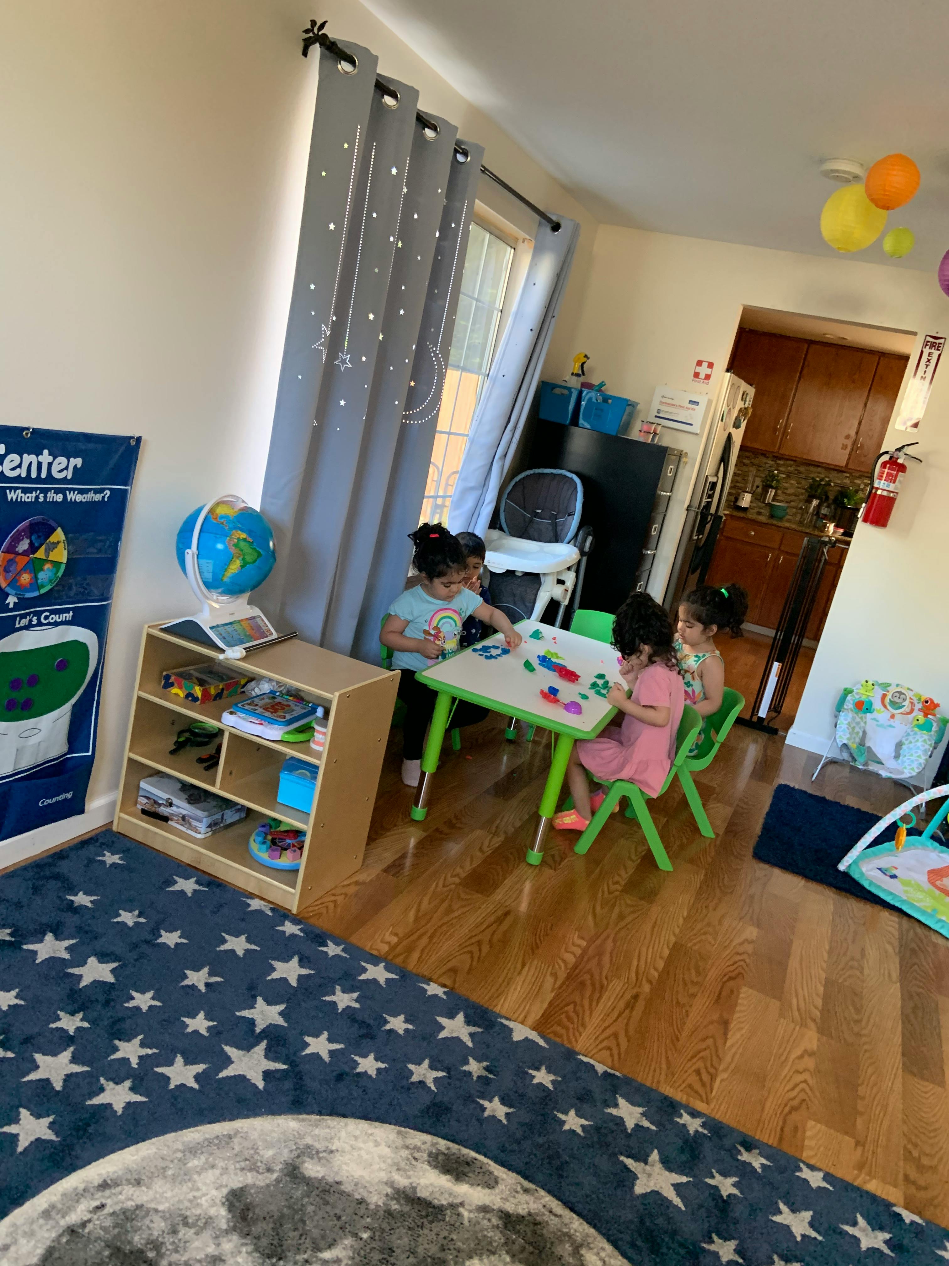 Children playing at a small table in a room