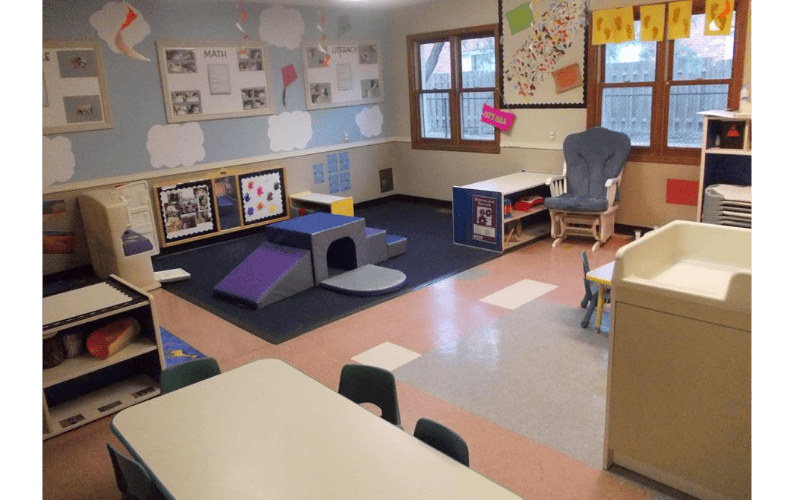 Classroom with play structures, tables, and learning displays