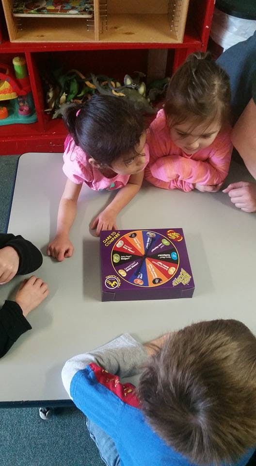 Children playing a board game on a table