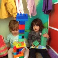 Two children playing with colorful building blocks