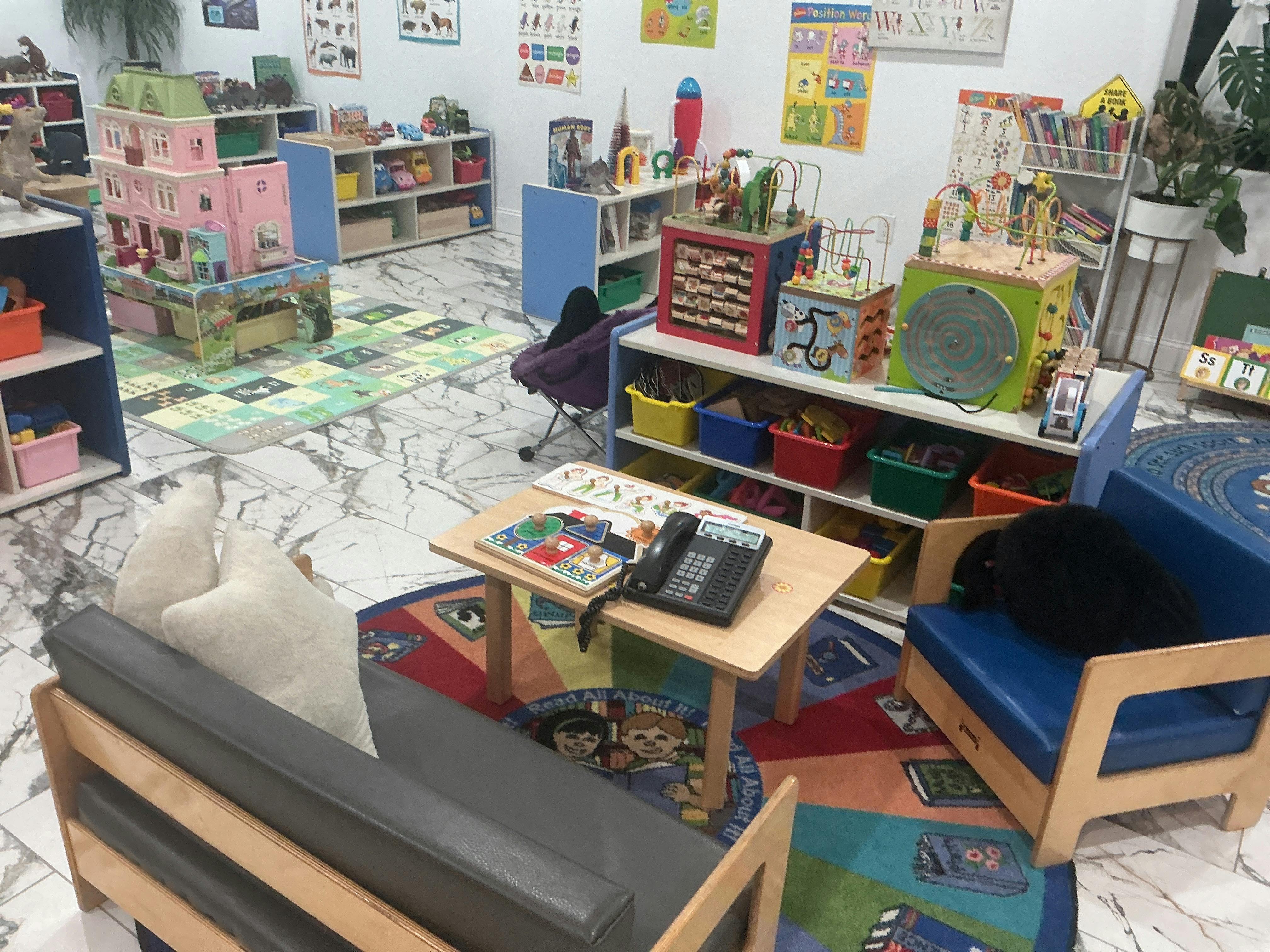 Children's classroom with toys, colorful rugs, and learning charts