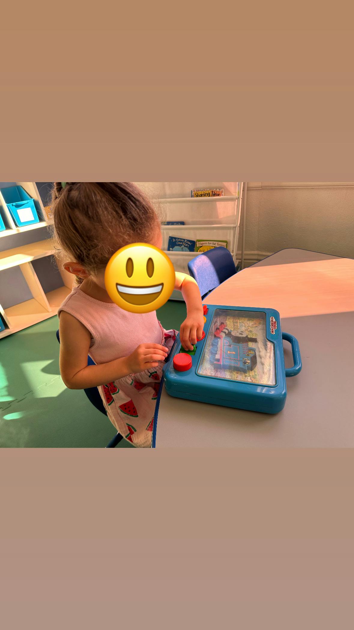 Child playing with a water game toy on a table