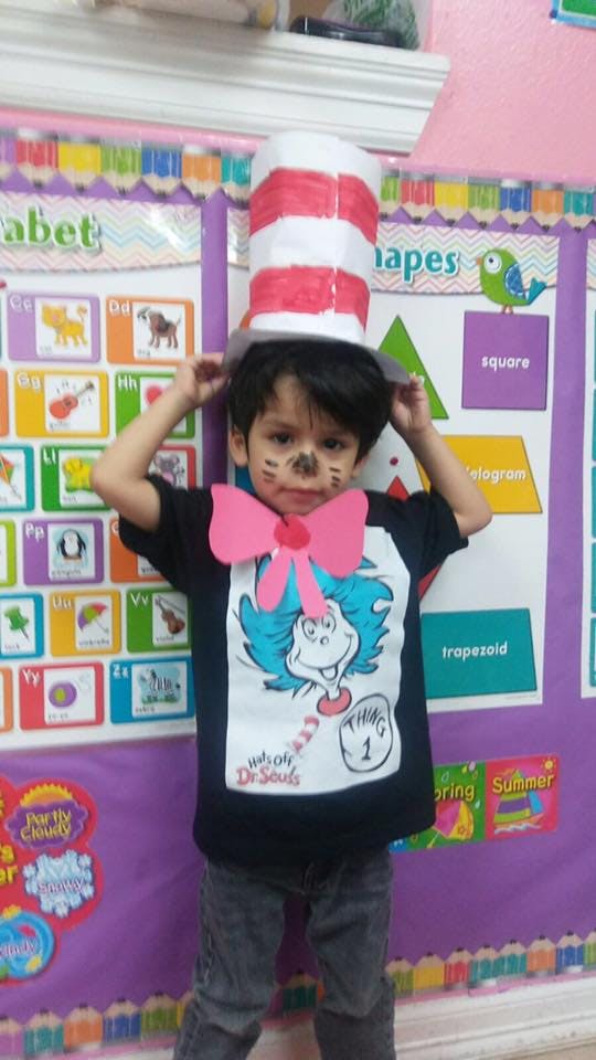 Child in a tall striped hat and a shirt with a cartoon character