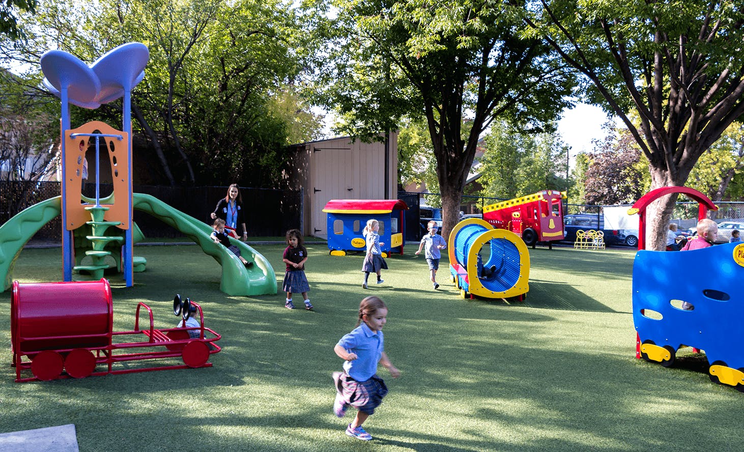 Children playing on a playground with slides and tunnels