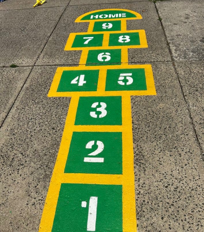 Hopscotch game painted on the ground with numbers 1-9 and "HOME"