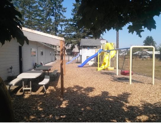 Picnic table and playground with slide and swings