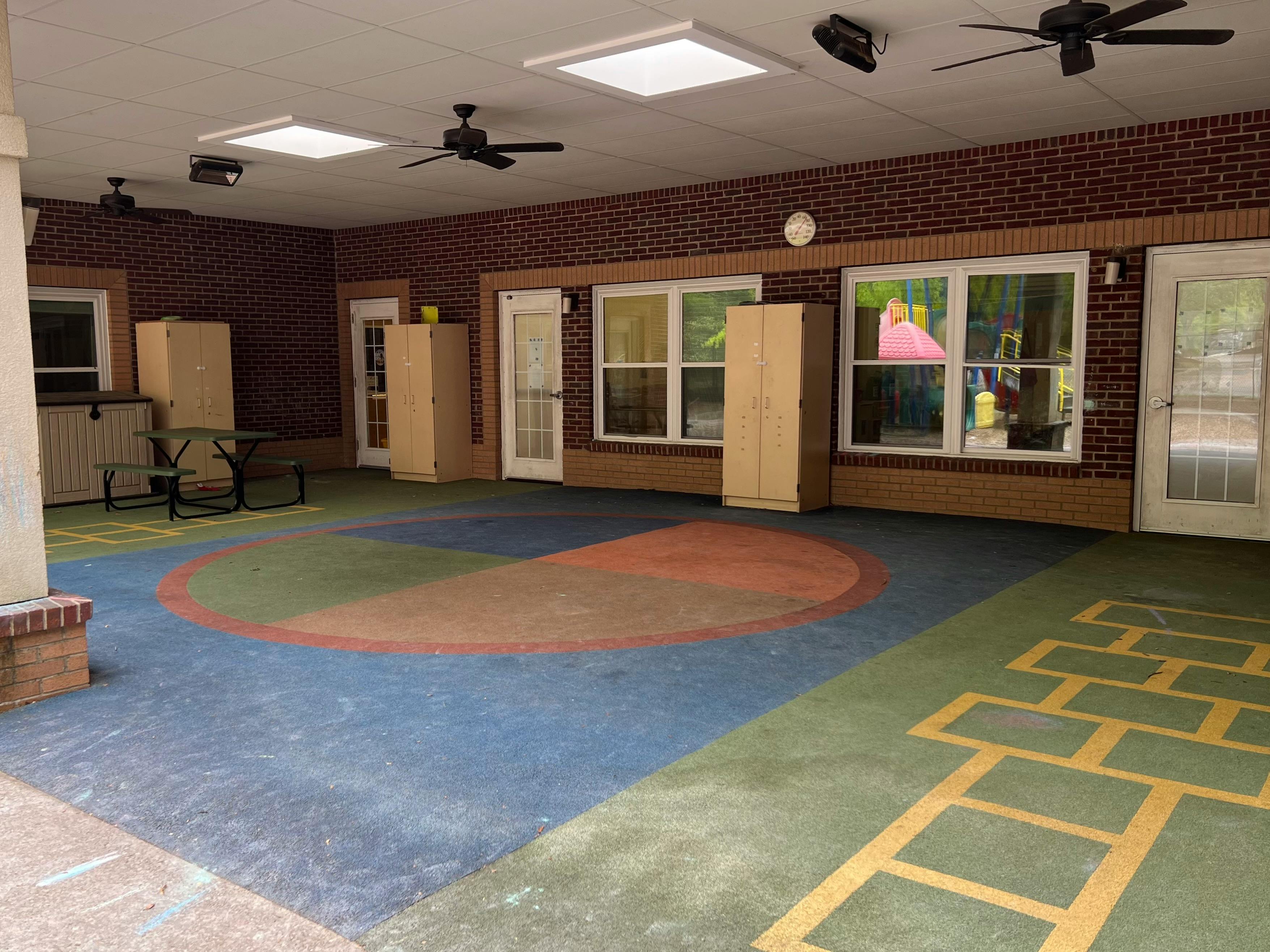 Outdoor covered play area with colorful floor markings