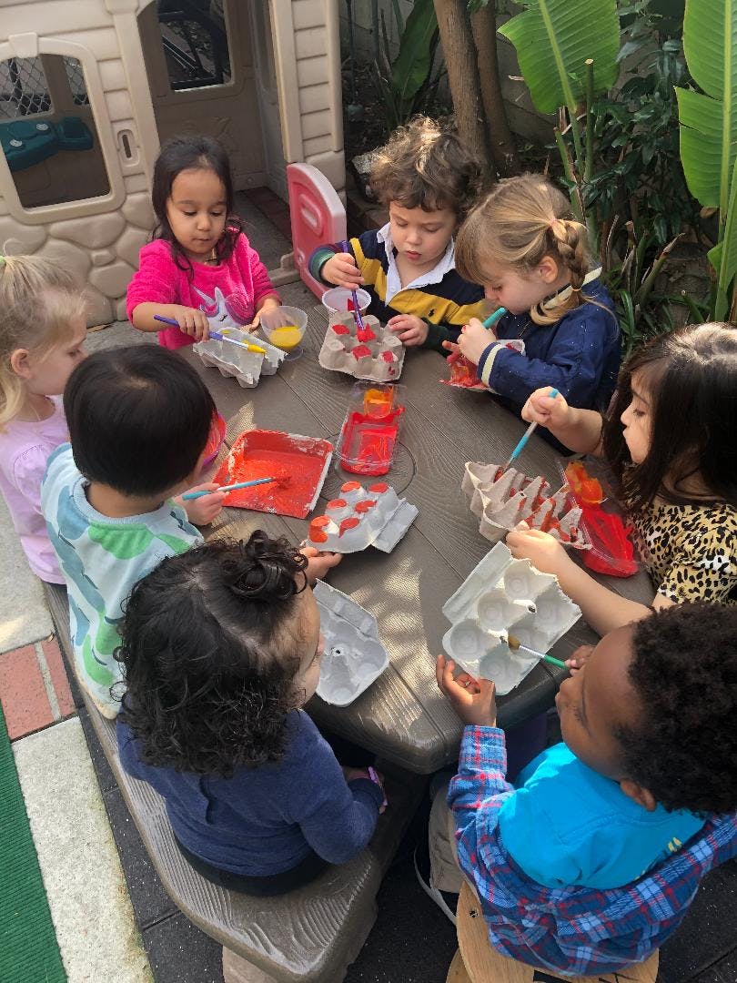 Children painting at a table