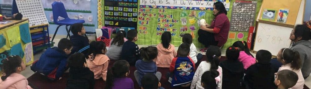 Person teaching children in a classroom