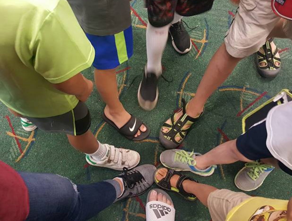 Feet of multiple children in a circle
