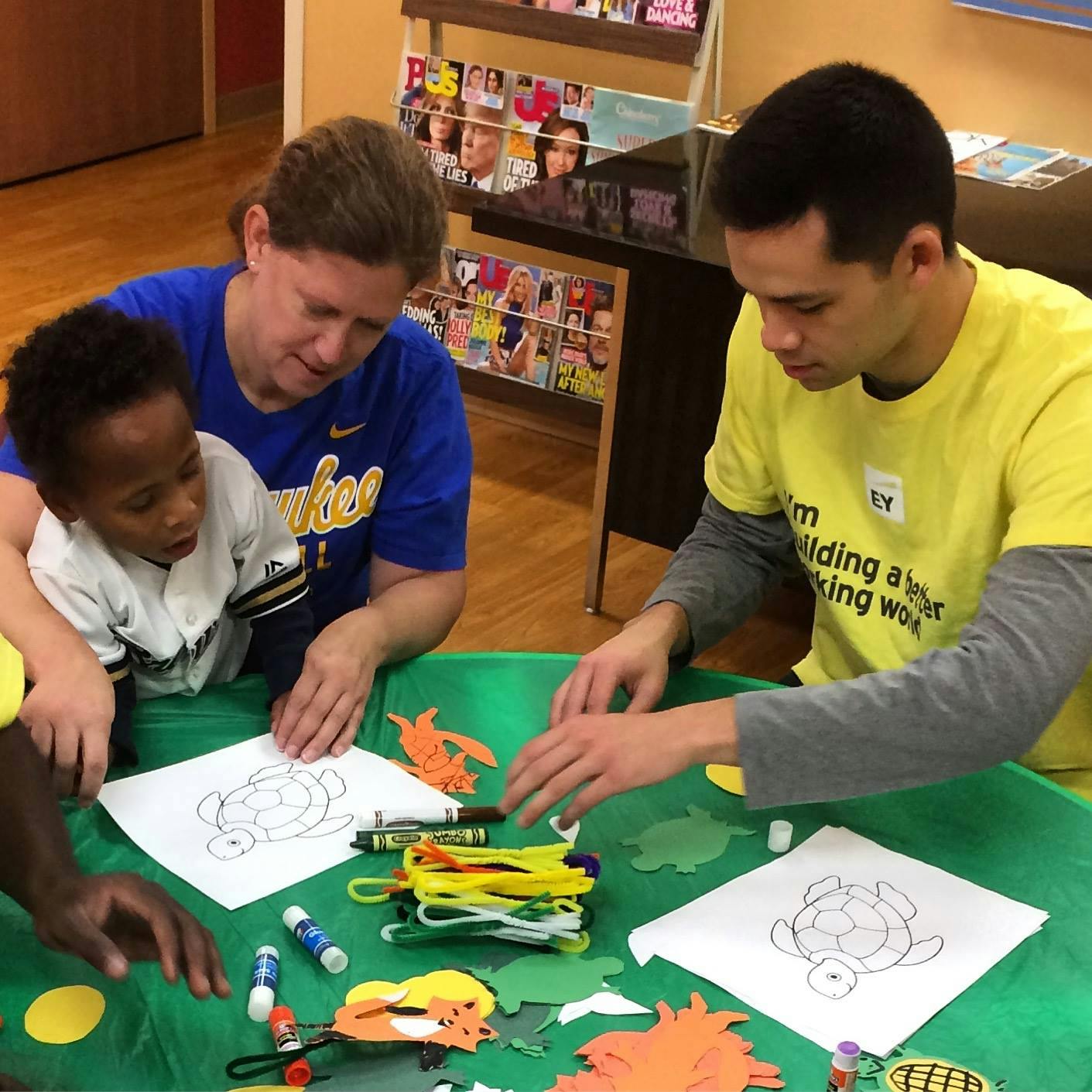 Adults and child doing crafts at a table