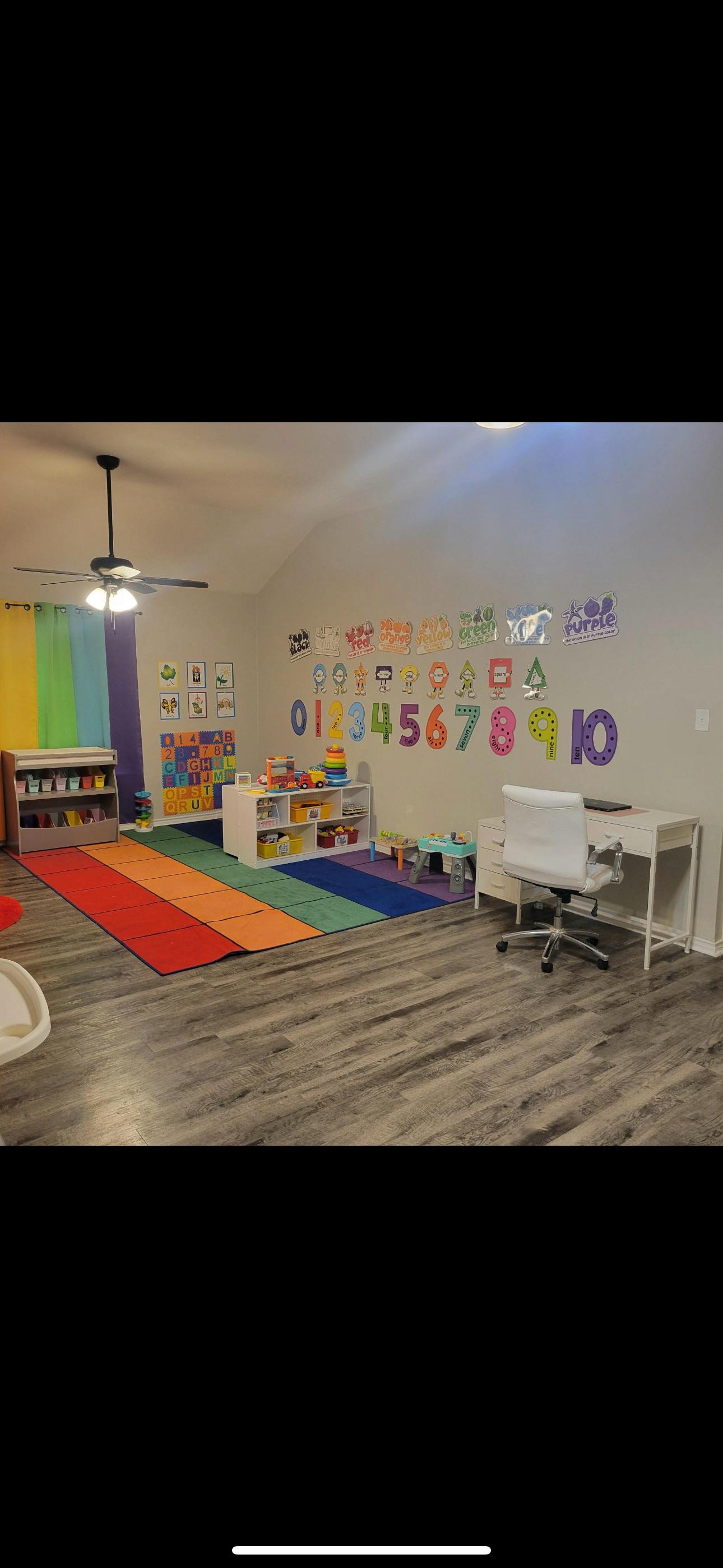 Classroom with colorful alphabet and number decals on the wall
