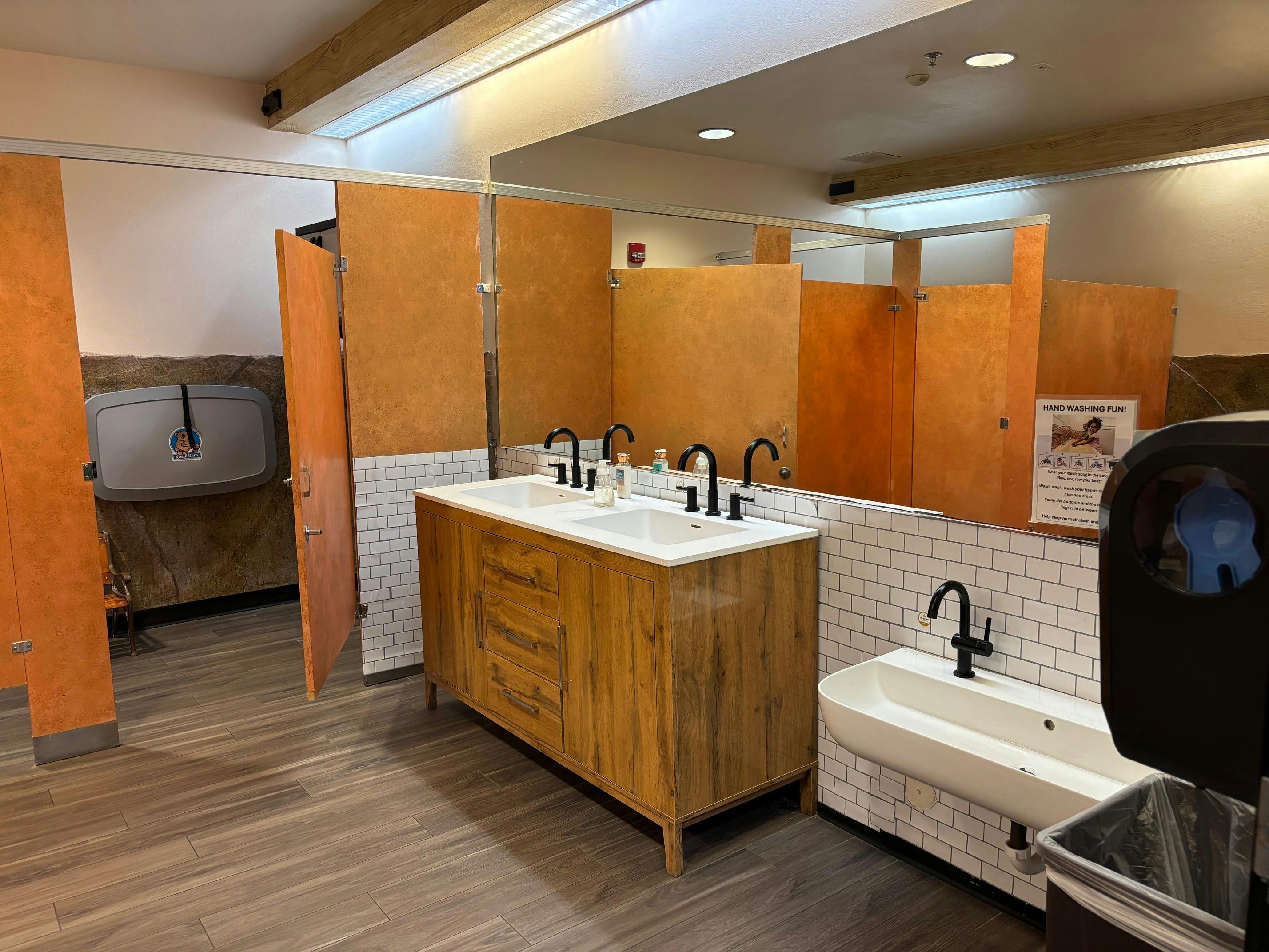 Public restroom with multiple sinks and stalls