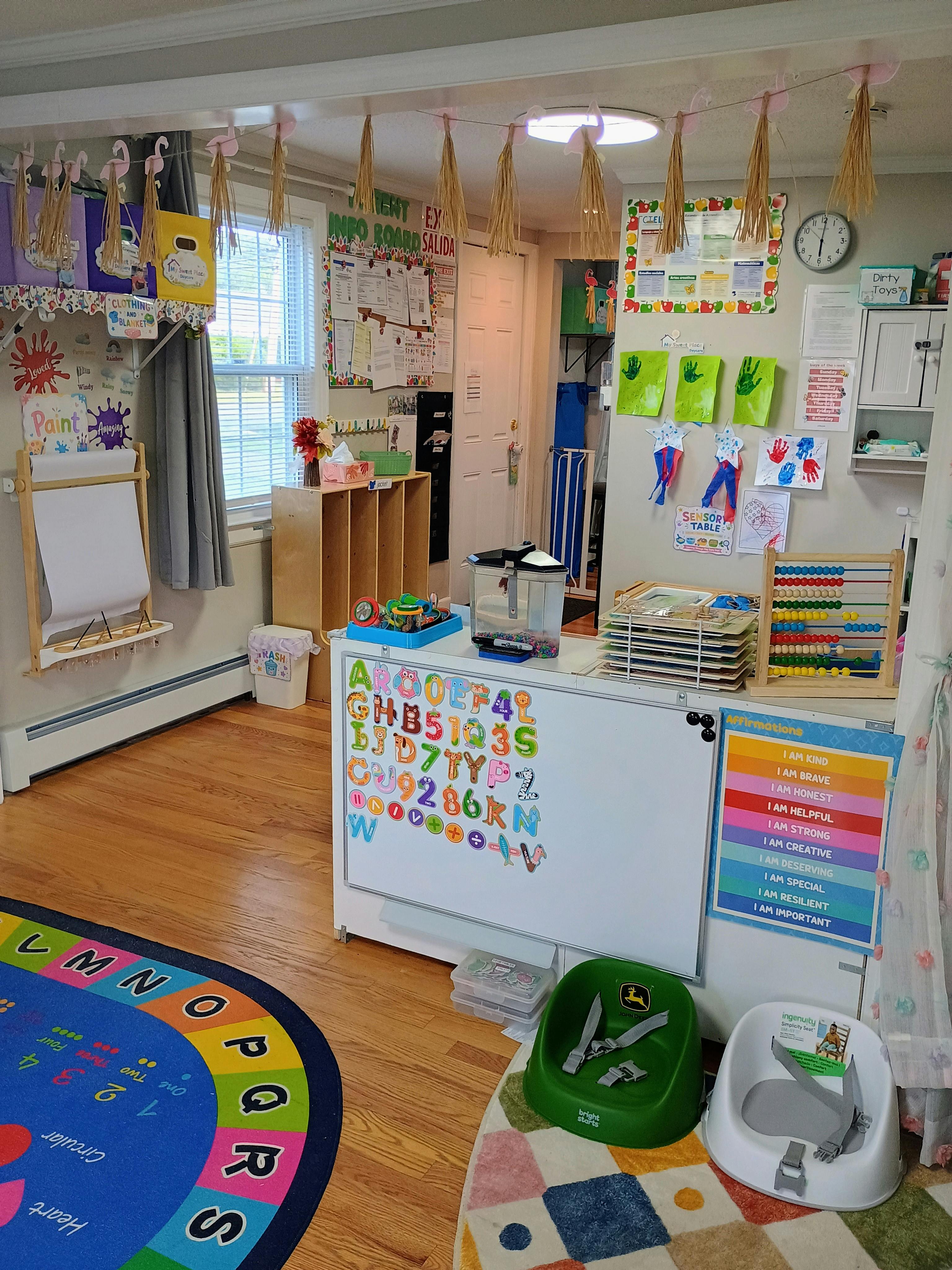Classroom interior with educational toys, activity boards, and learning rugs