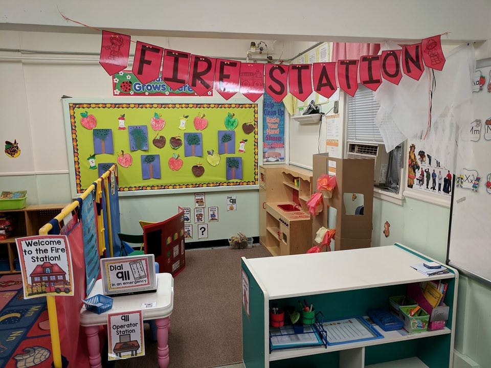 Classroom with a "Fire Station" banner and play area