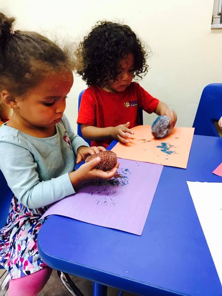 Two children doing crafts at a table