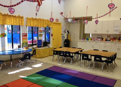 Classroom with tables, chairs, and colorful decorations