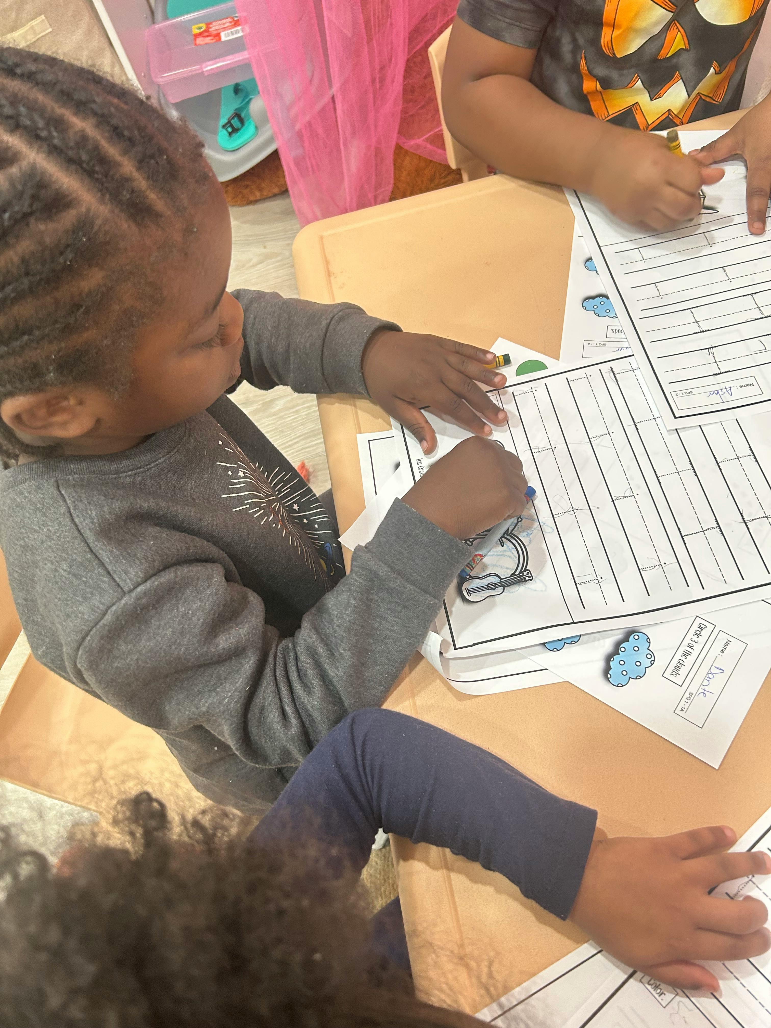 Child working on a worksheet at a table