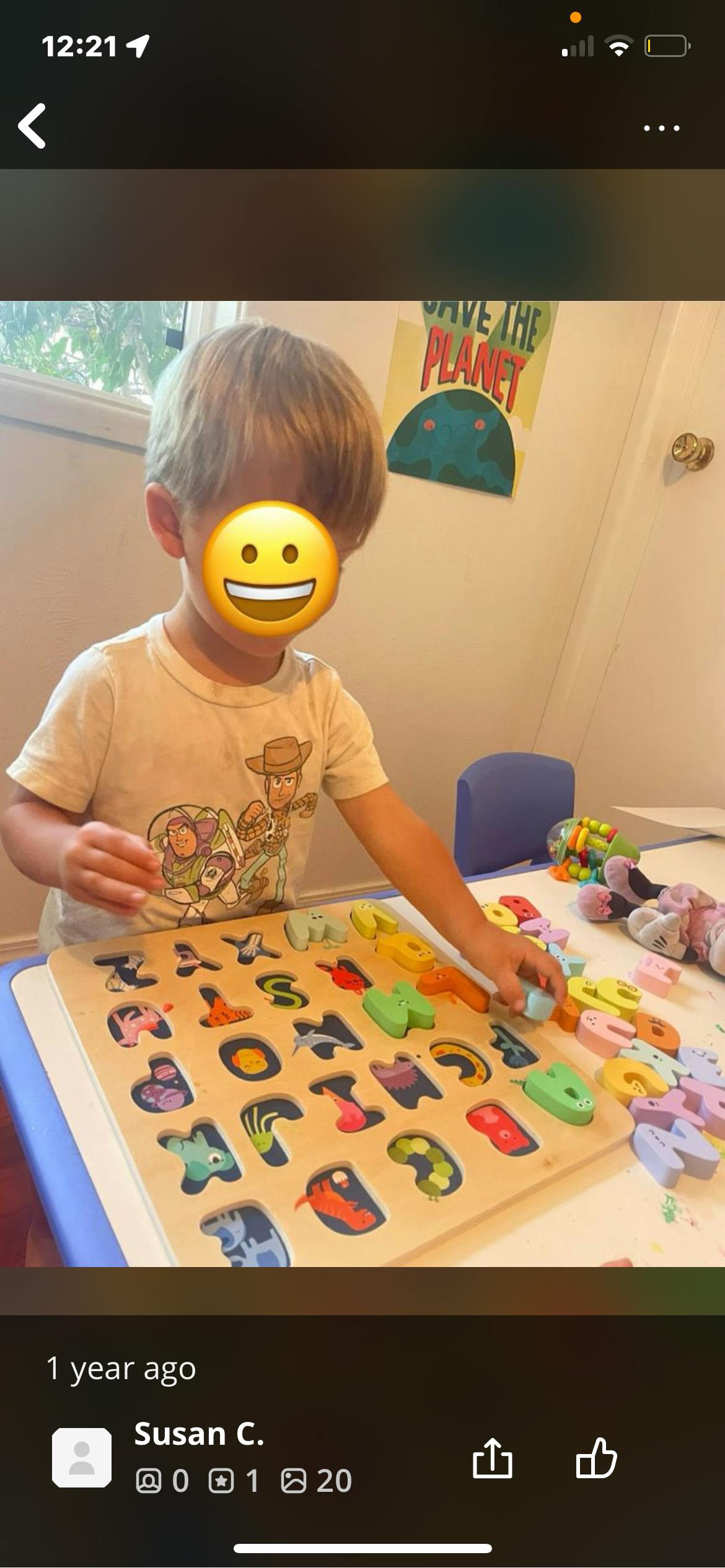 Child playing with a wooden alphabet puzzle
