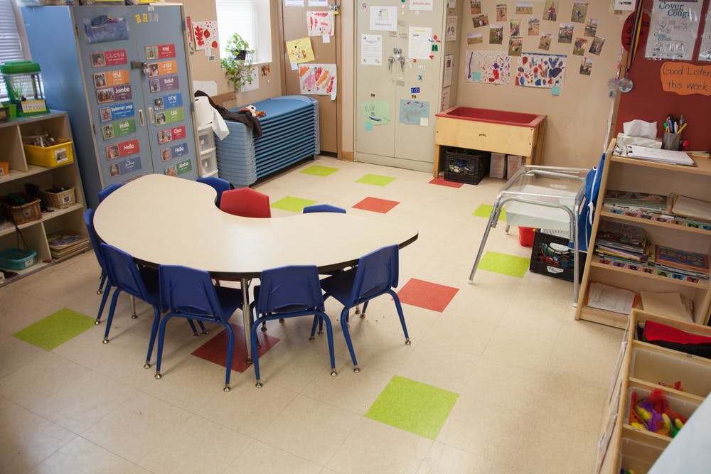 Classroom with a kidney-shaped table and blue chairs