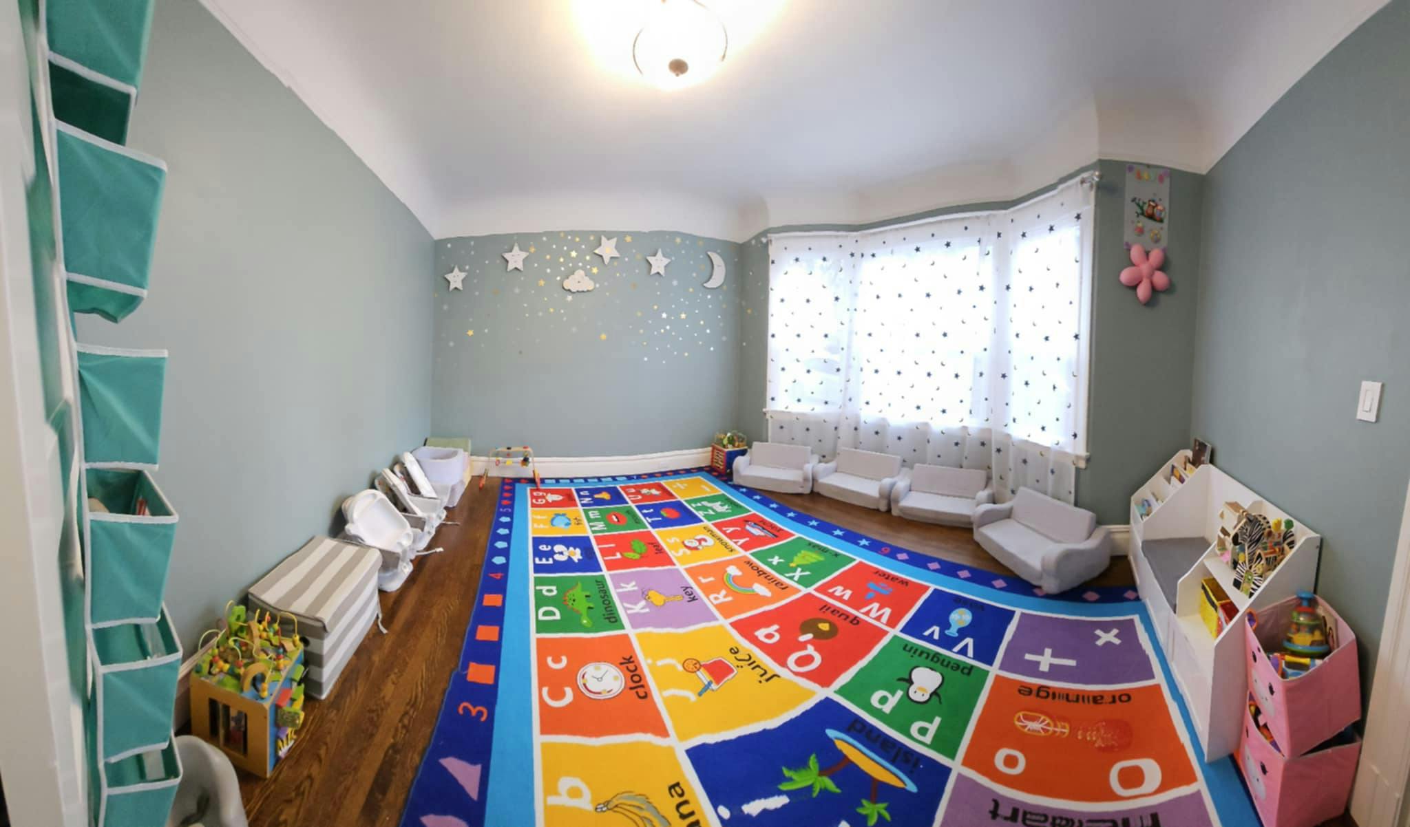 Playroom with a colorful alphabet rug and small chairs