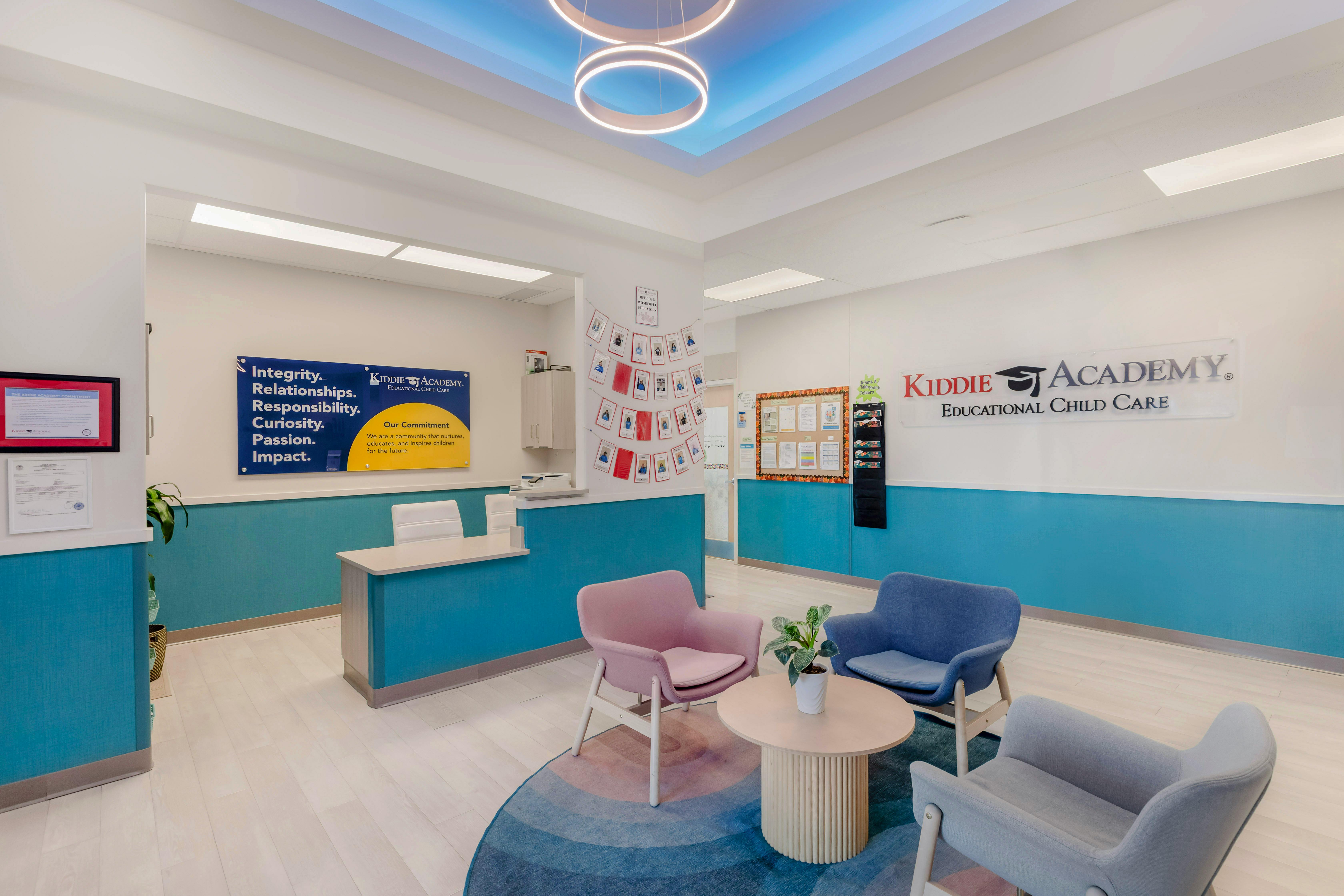 Reception area with a desk, seating, and a sign on the wall