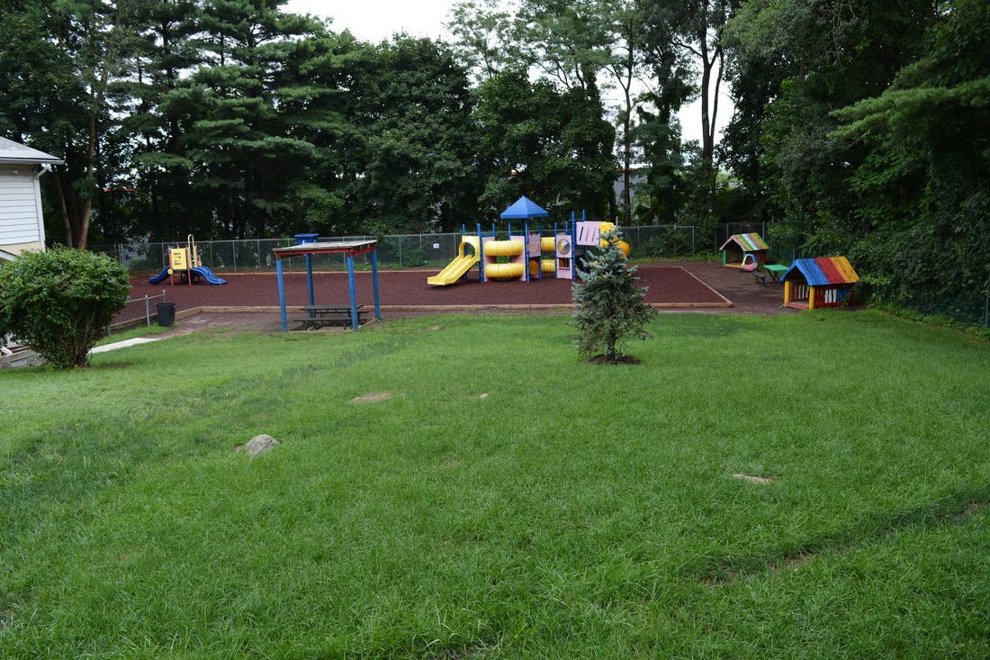 Playground with slides, climbing structures, and small playhouses