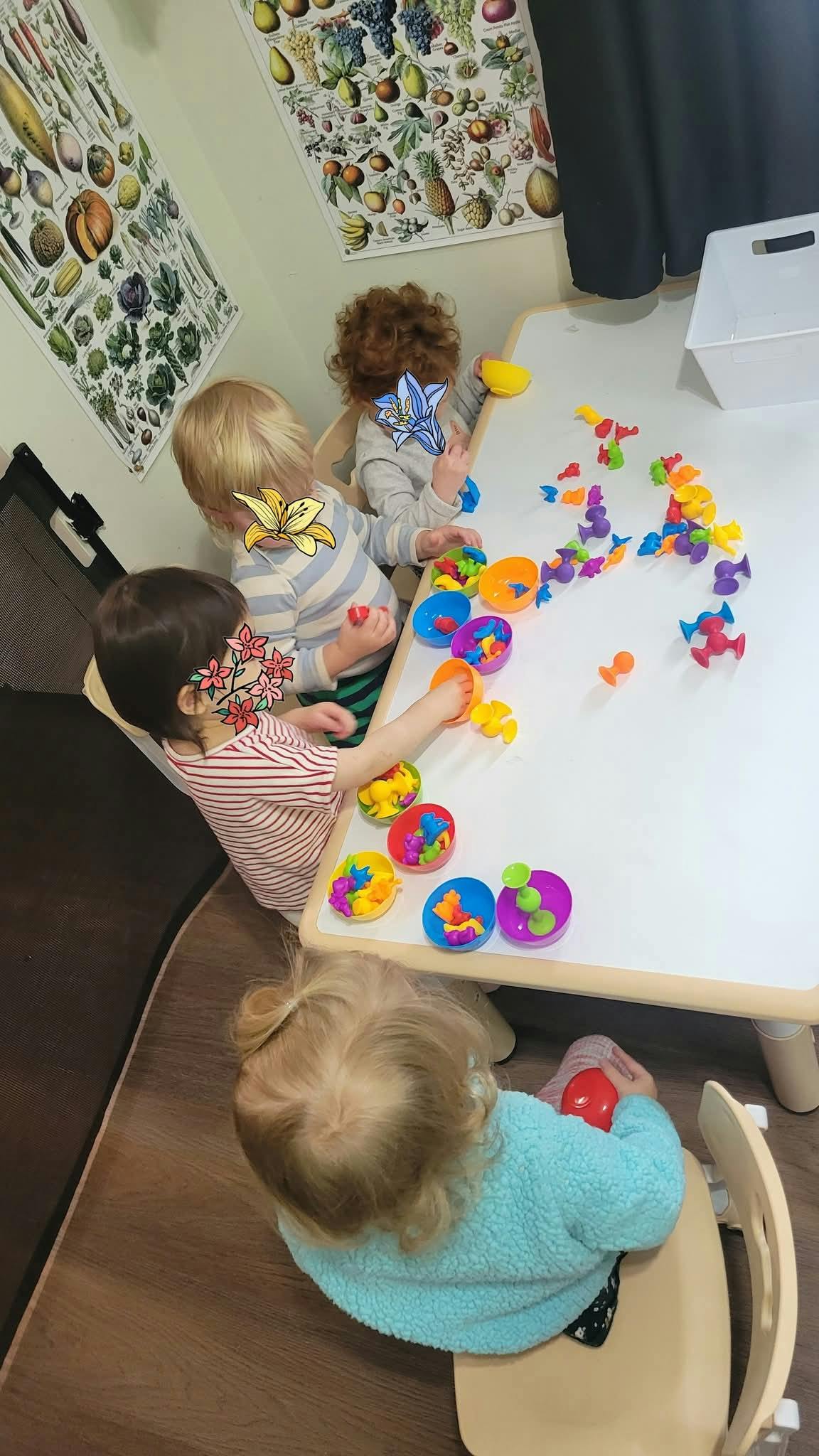 Children playing with colorful toys at a table