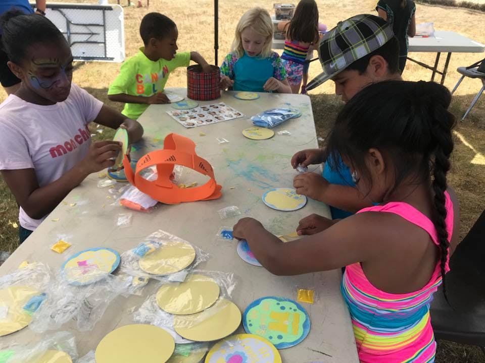 Children making crafts at a table