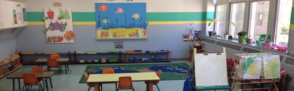 Classroom with small tables and chairs, colorful wall decorations