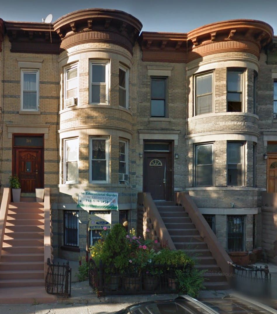 Row of residential buildings with bay windows and front stoops