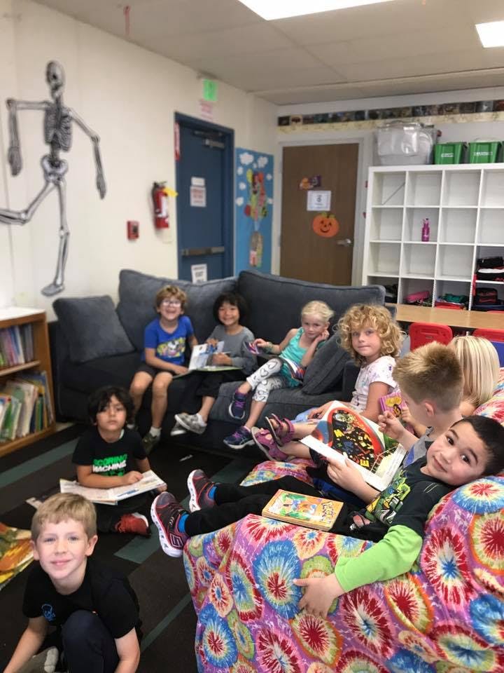 Children reading books in a classroom
