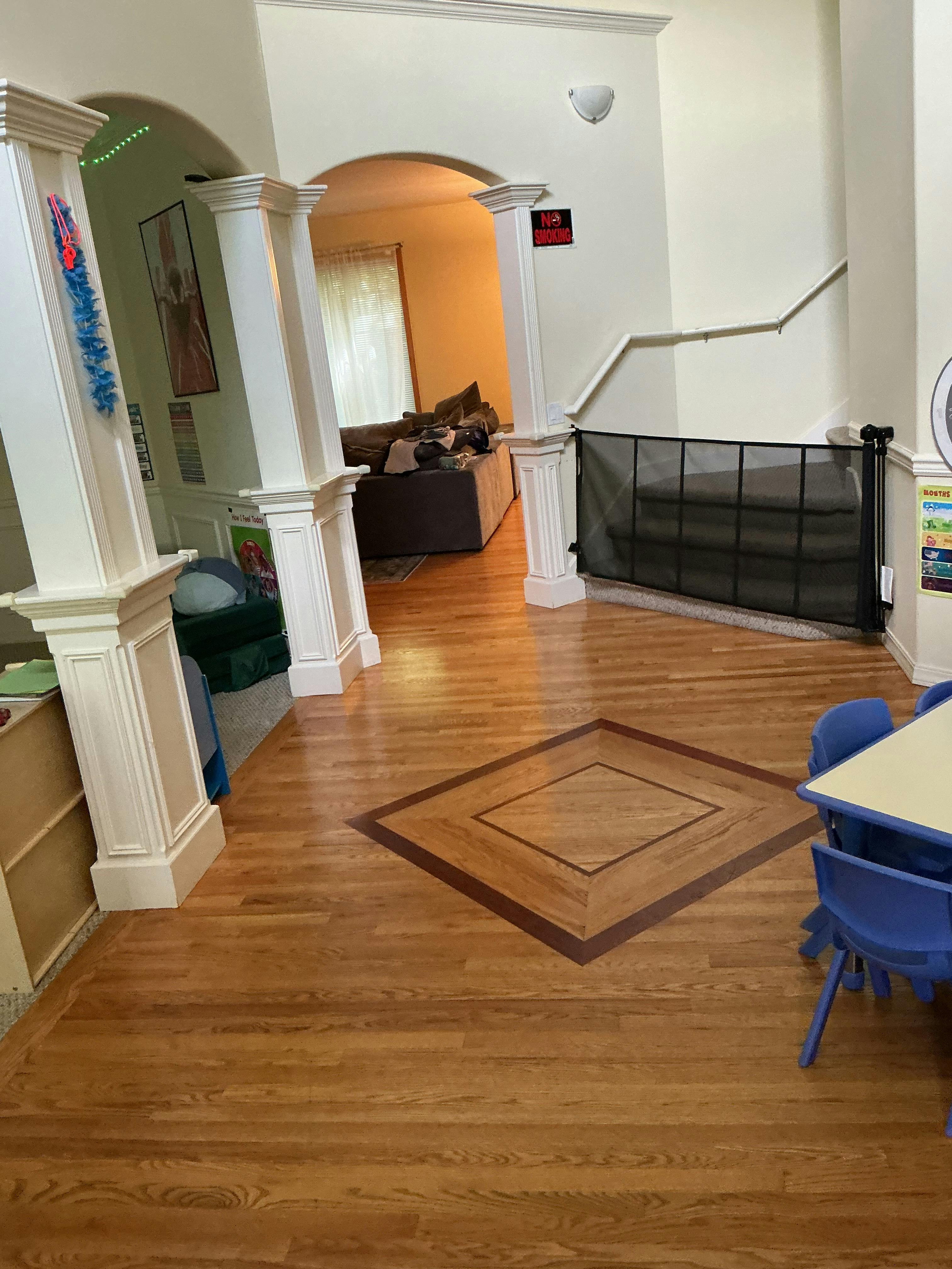 Spacious room with wooden floors and child-sized furniture