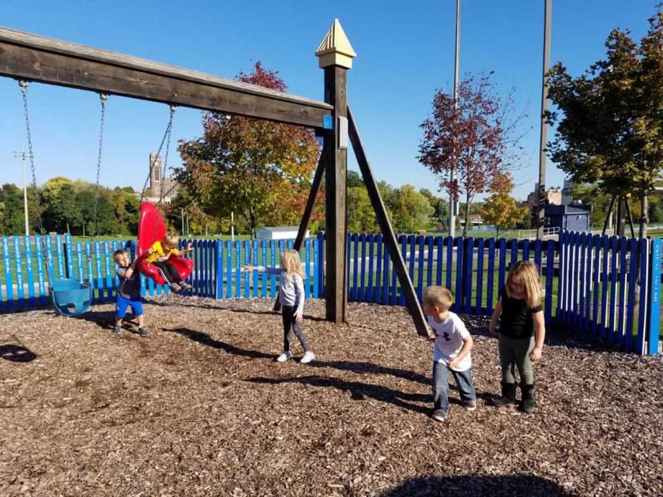 Children playing on a swing set in a playground